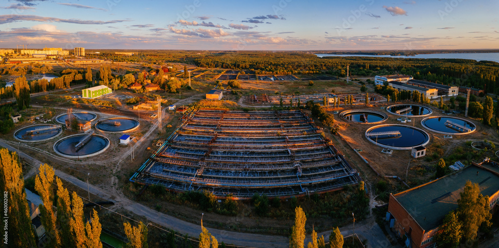 Modern wastewater treatment plant, aerial view from drone at the evening sunset