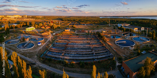 Modern wastewater treatment plant, aerial view from drone at the evening sunset