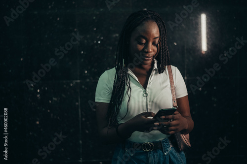 African american woman using smartphone while out in the city