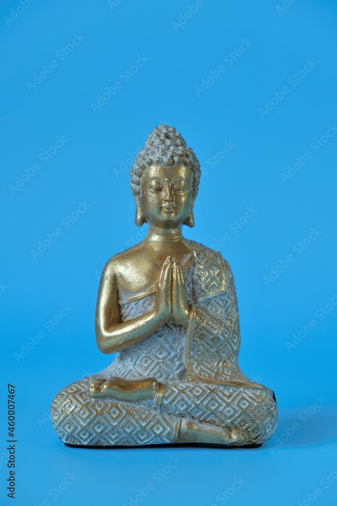 Buddha statue on a blue background.Meditation and relaxation .Buddhism religion background. Buddha statue on a blue background.Meditation and relaxation .Buddhism religion background.