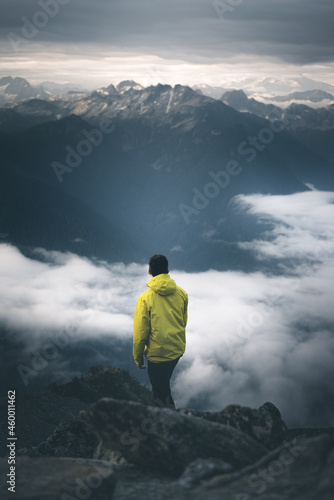 Man posing in dramatic mountain scene.