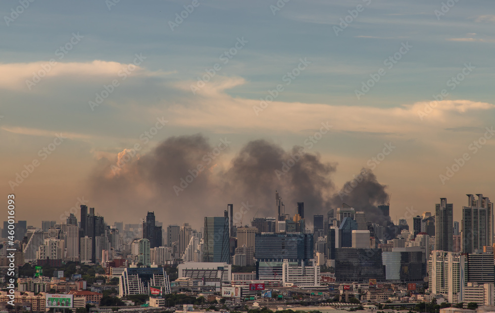 Bangkok, Thailand - Jun 23, 2020 : Aerial photograph of a group of black smoke rising from a fire on a tall building in Bangkok.