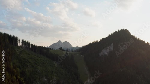 Aerial view of a house on top of Unternberg alps, sunset in Austria - rising, drone shot photo