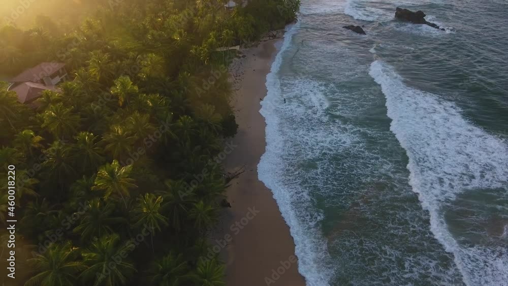 Waves Crashing along the shoreline at sunset aerial view Waves Crashing along the shoreline at sunset aerial view