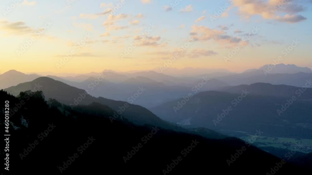 Hyperlapse Drone shot of clouds moving over mountains in Kampenwand, colorful sunset sky, in Germany - Aerial dronelapse view Hyperlapse Drone shot of clouds moving over mountains in Kampenwand, colorful sunset sky, in Germany - Aerial dronelapse view