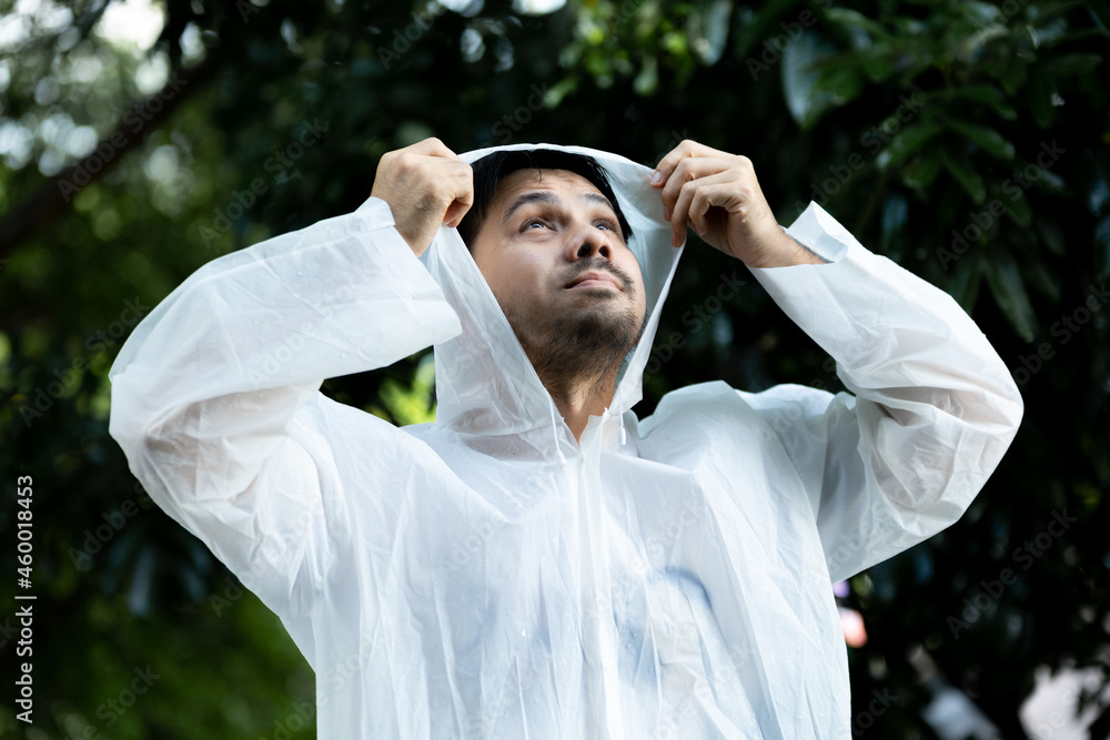 Portrait Asian Man in a white raincoat standing In Forest During Rain Portrait Asian Man in a white raincoat standing In Forest During Rain