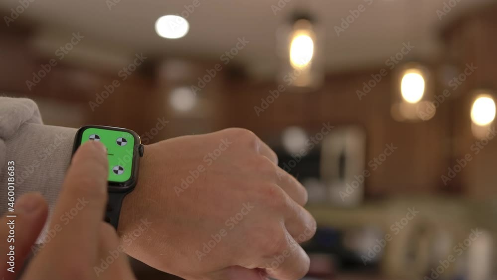 A man uses a smart watch with a chromakey on a green screen. A smart watch on a man's wrist. A layout for tracking or viewing content in 4K format. Close-up. High quality 4k footage A man uses a smart watch with a chromakey on a green screen. A smart watch on a man's wrist. A layout for tracking or viewing content in 4K format. Close-up. High quality 4k footage