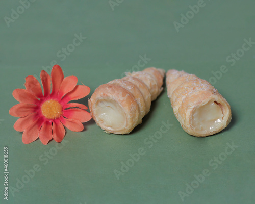 In Indonesia, this cake is known as cumcum cake. A cake shaped like a trumpet, or an ice cream cone. The perfect combination of a dry cake studded with sugar, plus a delicious cream vanilla filling. photo