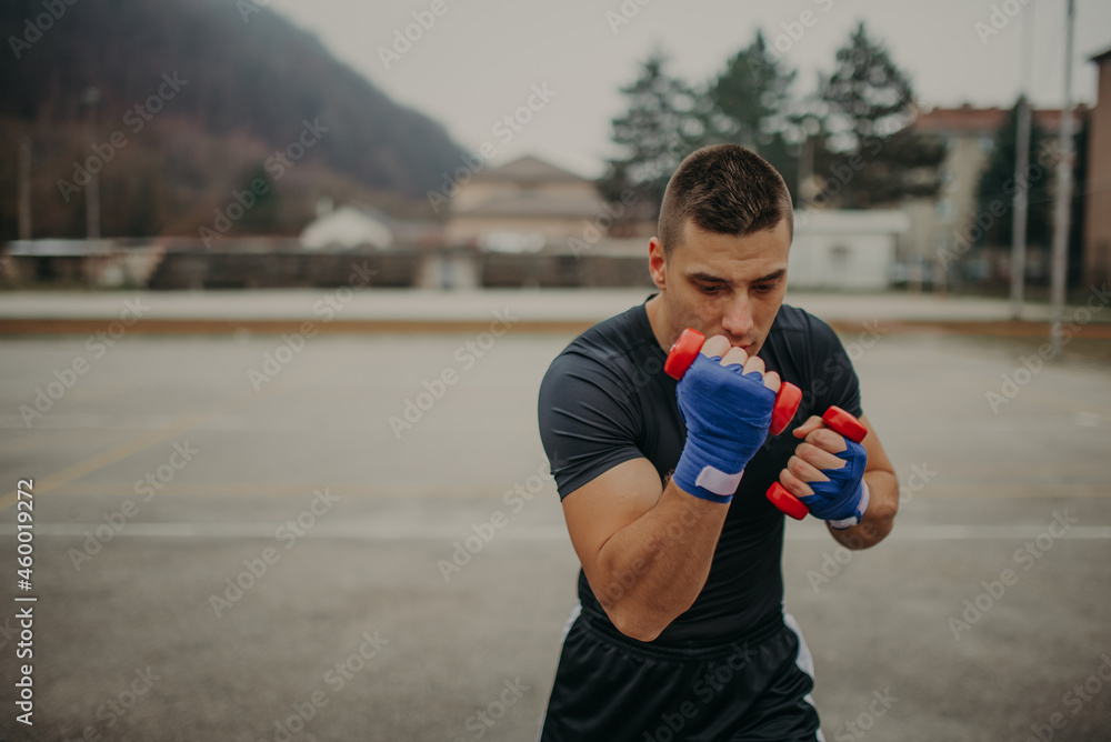 Fototapeta premium Strong professional boxer training in action. Professional fighter, boxer.