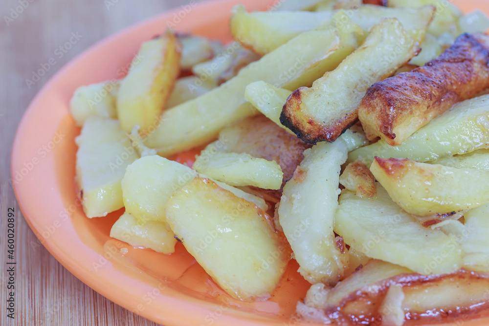 fried potatoes in a plate on a wooden board macro fried potatoes in a plate on a wooden board macro