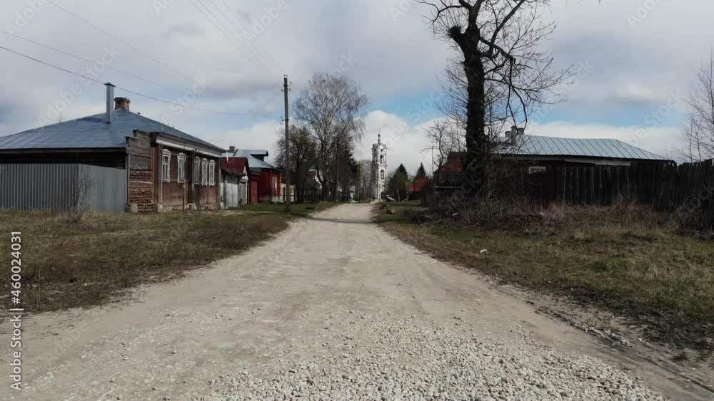 a country road in a Russian village with a temple in the center. filmed from drone a country road in a Russian village with a temple in the center. filmed from drone