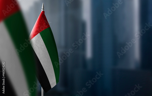 Bilde på lerret Small flags of United Arab Emirates on a blurry background of the city