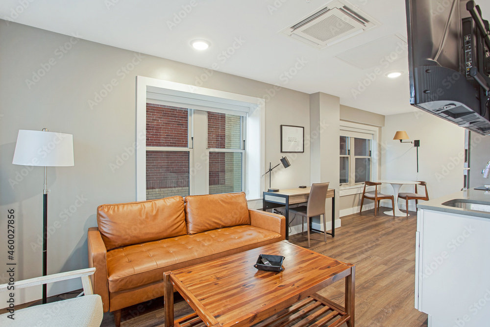 Fototapeta premium Small studio apartment in city with hardwood floors and open floor plan