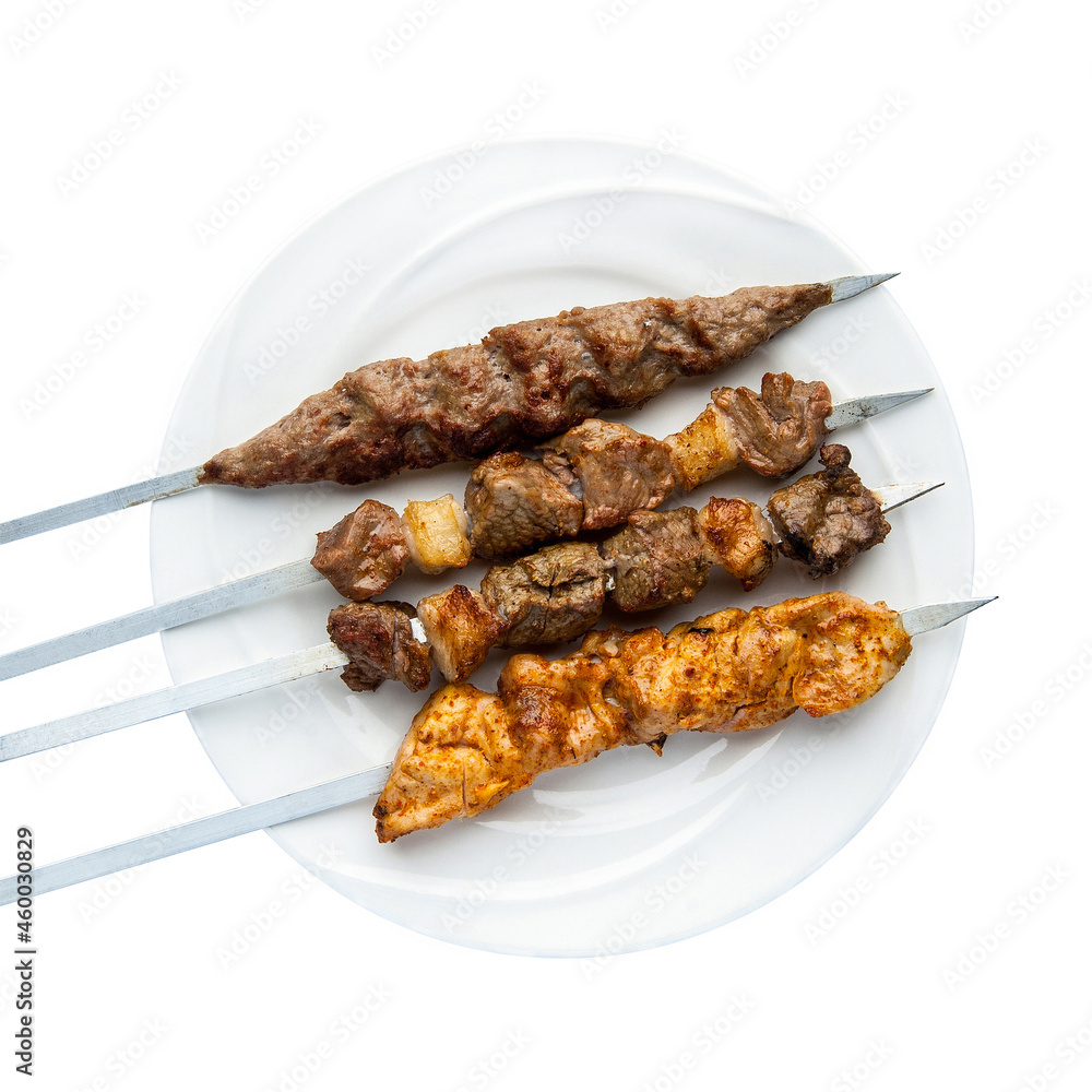 Kebab on skewers in a plate on a white background.  Top view. Isolated. Barbecue