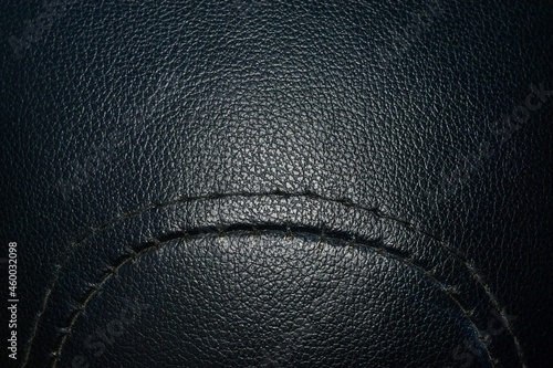 Black leather background texture, seam stitching, curved lines. © ประพันธ์ บุญเหมาะ