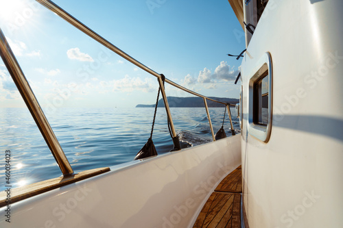 Deck of white yacht sailing in open sea at sunset © fotofabrika
