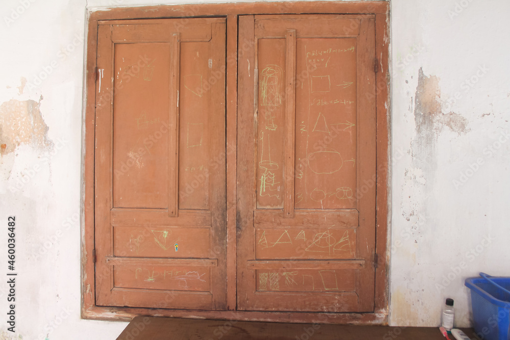 brown wooden window full of colored pencil scribbles brown wooden window full of colored pencil scribbles