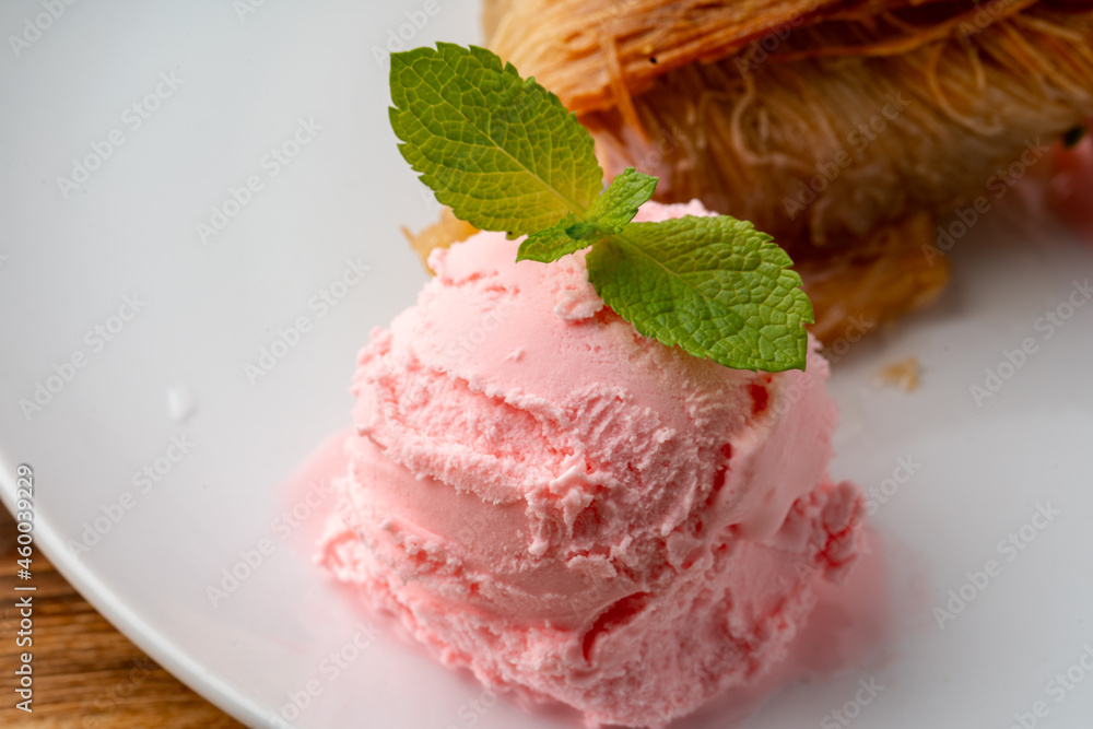 Close up photo of Turkish baklava served with ice cream Close up photo of Turkish baklava served with ice cream