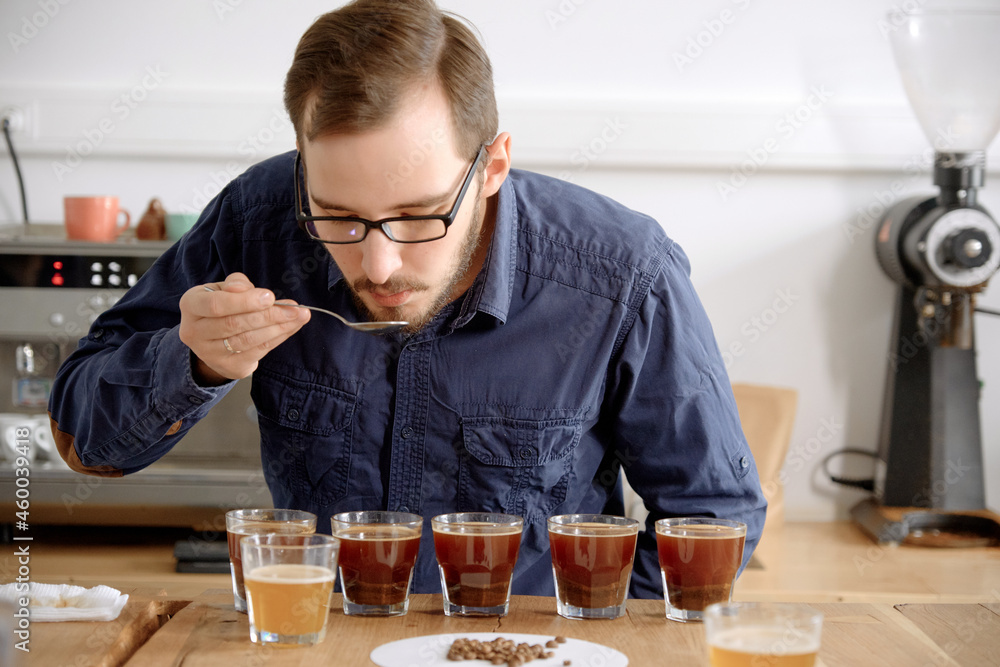 Barista examining freshly brewed coffee Barista examining freshly brewed coffee