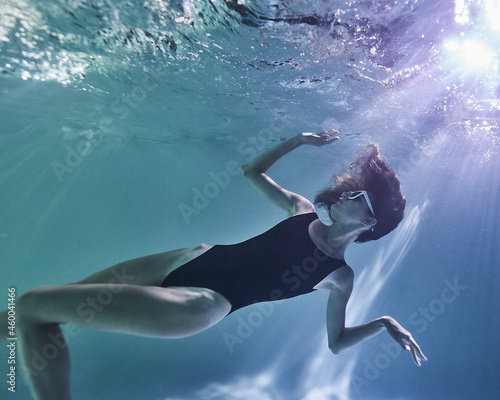 fashion girl posing in the pool underwater © Pavel Karchevskii