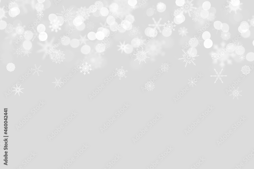 snowflakes on a light gray background with bokeh and place for text. Christmas and New Year pattern. Backdrop  for postcards