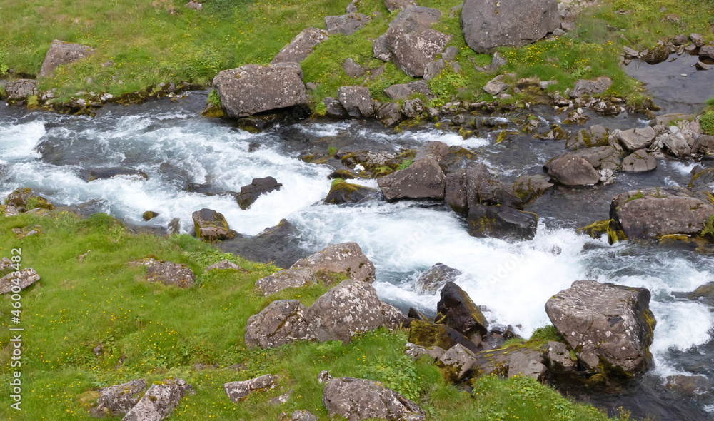 Fast flowing river at the bottom of the Dynjandi. The Dynjandi is the most famous waterfall of the West Fjords, Iceland Fast flowing river at the bottom of the Dynjandi. The Dynjandi is the most famous waterfall of the West Fjords, Iceland