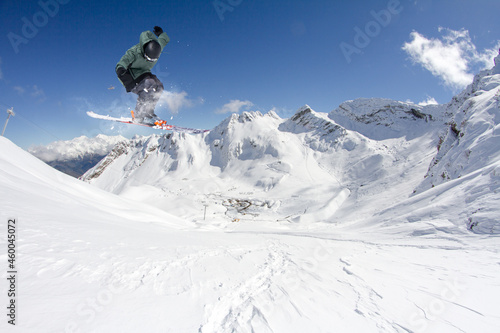 A jumping skier in the mountains. Mountain ski, winter extreme sport. © Vasily Merkushev