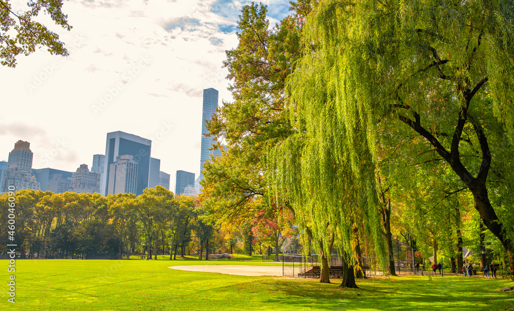NEW YORK CITY, USA - OCTOBER 25TH, 2015: Tourists and locals visit Central Park in autumn season. It is a main city attraction. NEW YORK CITY, USA - OCTOBER 25TH, 2015: Tourists and locals visit Central Park in autumn season. It is a main city attraction.