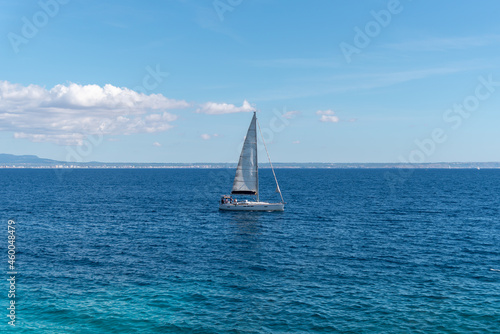 Small sailboat at sea on a sunny day 