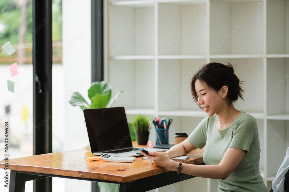 Happy asian woman using mobile phone at modern office Happy asian woman using mobile phone at modern office