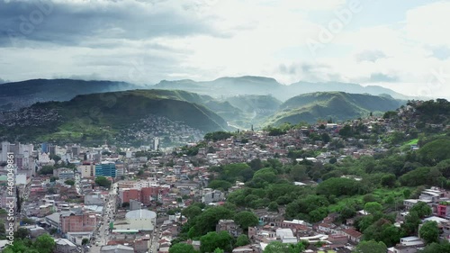 Aerial view Tegucigalpa Honduras. Cityscape of the capital with houses on the slopes of the mountains, a sunny day with clouds and peaks with mountain ranges. photo