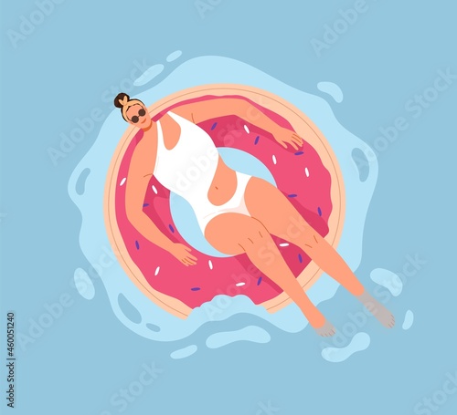 Happy woman swimming in pool water with inflatable donut ring. Person enjoyin...