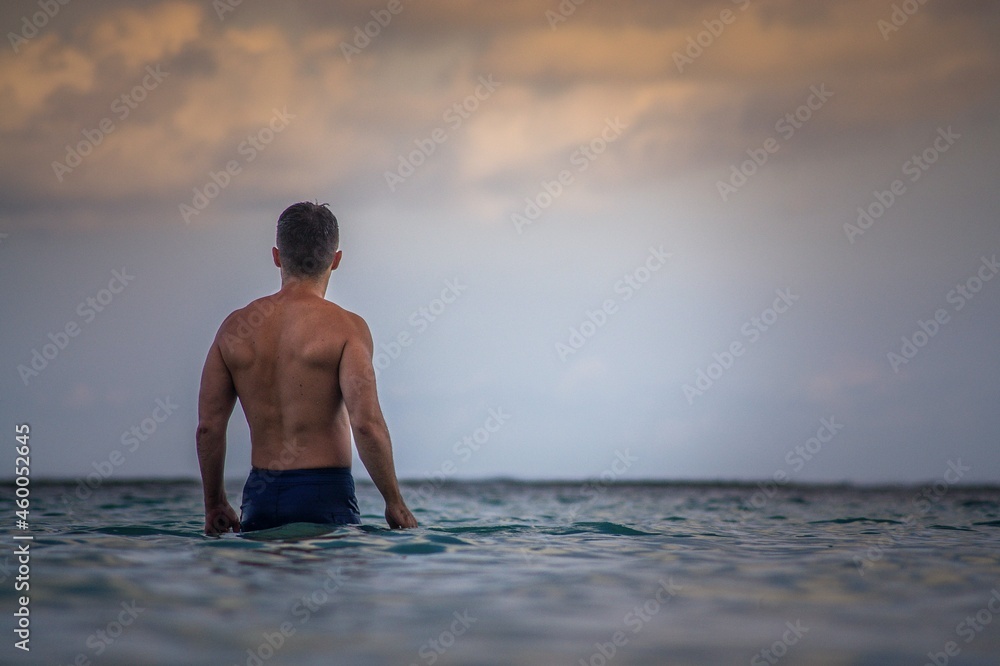 Аa muscule man at sea looks into the distance. Bali.