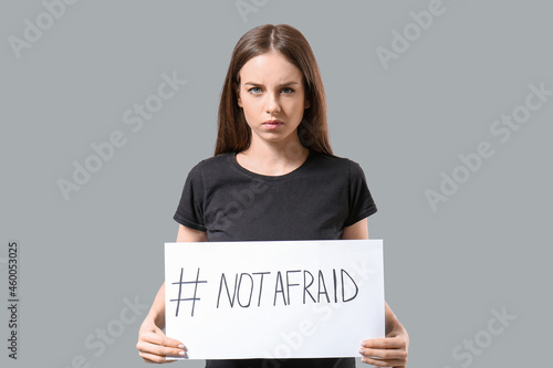 Young woman holding paper w...