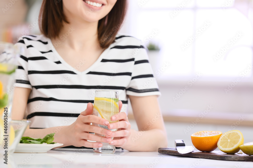 Beautiful young woman with fresh lemonade at home Beautiful young woman with fresh lemonade at home