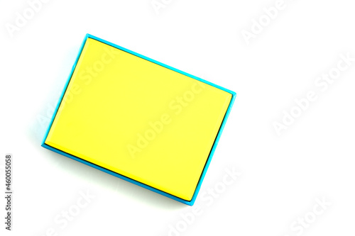 Blue cardboard box with yellow lid isolated on white background