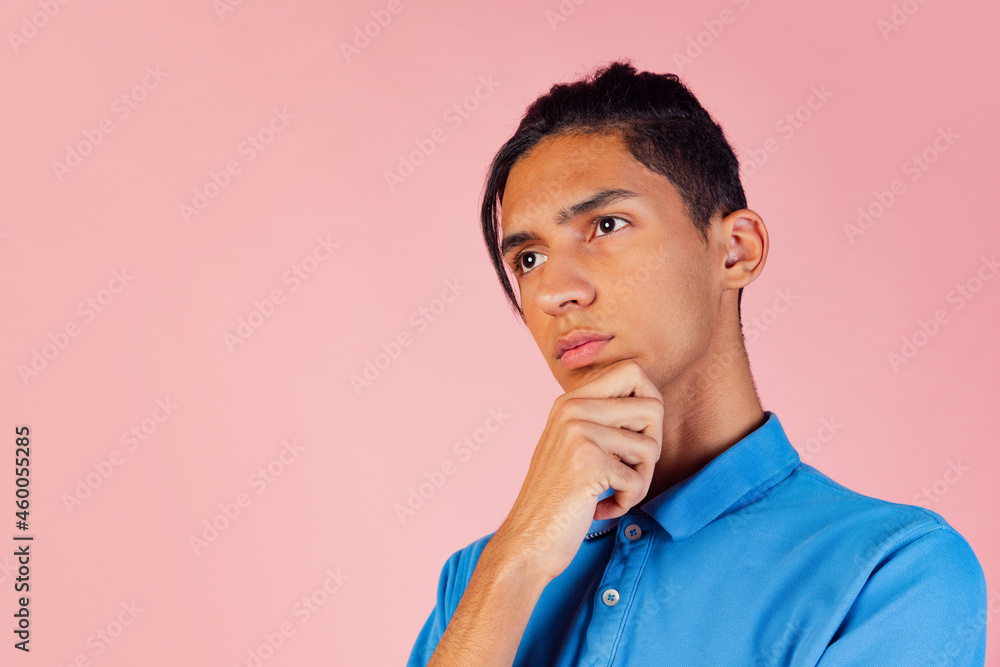 Portrait of young teen boy, student wearing blue shirt posing isolated on pink studio backgroud. Human emotions concept. Portrait of young teen boy, student wearing blue shirt posing isolated on pink studio backgroud. Human emotions concept.