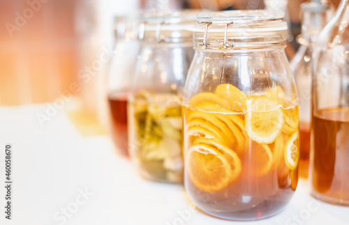 Homemade fermented raw kombucha tea with different flavorings, as  lemon organic probiotic drink. photo