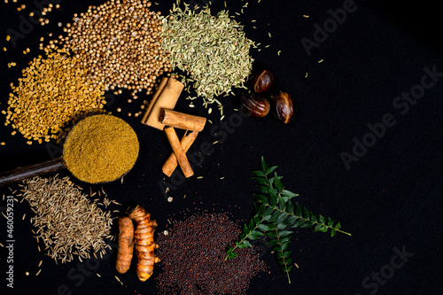 Various spices, turmeric, ginger, cumin seeds, cinnamon and herbs close-up top view. Eastern spice market. A set of peppers and spices for cooking.