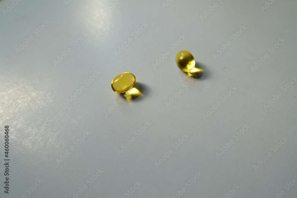 Two yellow softgel capsules of vitamin A (retinyl palmitate) Two yellow softgel capsules of vitamin A (retinyl palmitate)