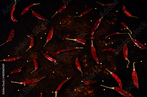 Pile crushed red pepper, Cayenne pepper, dried chili flakes isolated on black background