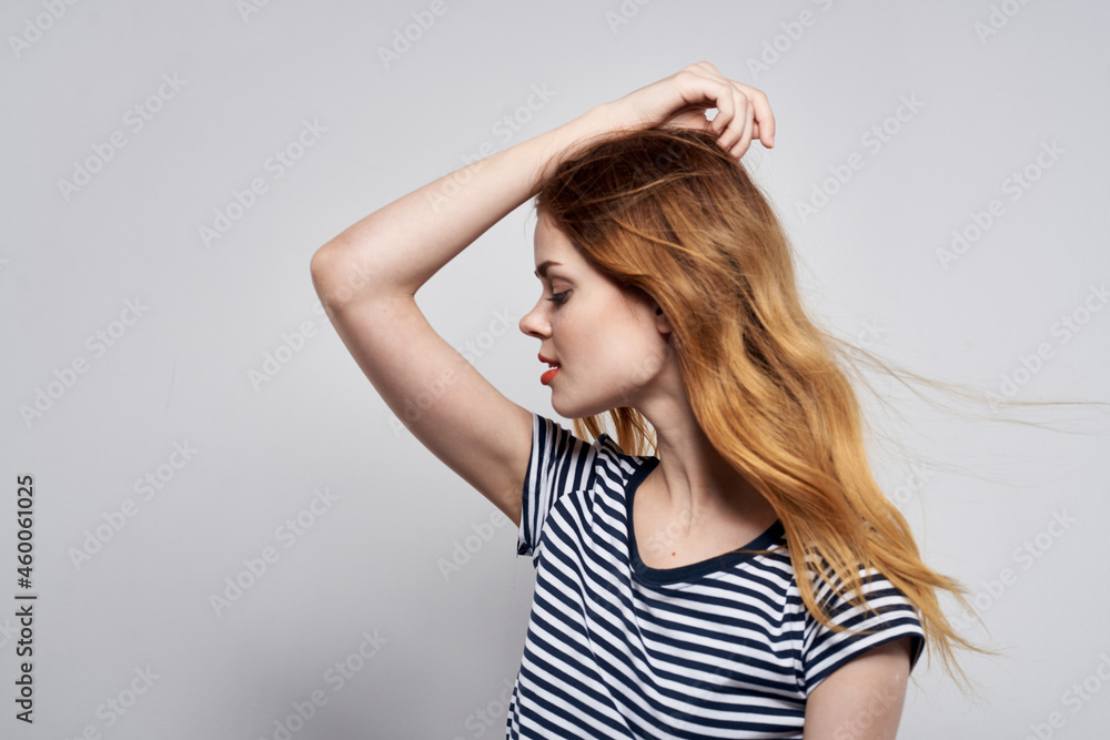 beautiful woman in a striped t-shirt gesture with his hands model studio beautiful woman in a striped t-shirt gesture with his hands model studio