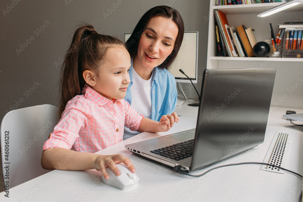 mom helps daughter do homework remotely on laptop mom helps daughter do homework remotely on laptop