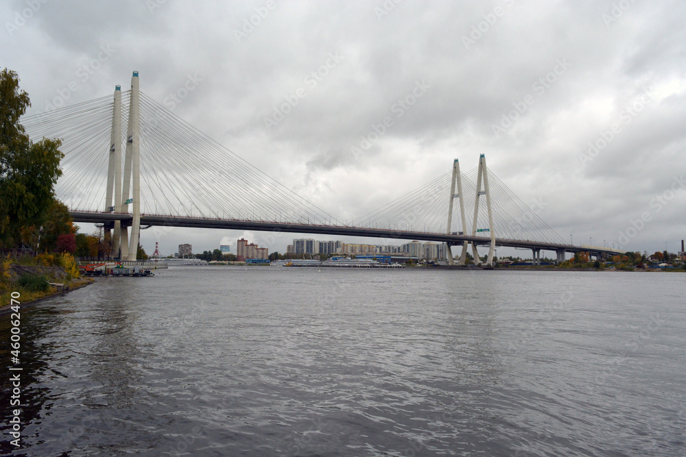 Naklejka premium The Bolshoy Obukhovsky Bridge (Saint Petersburg, Russia) across the Neva river on grey cloudy weather.