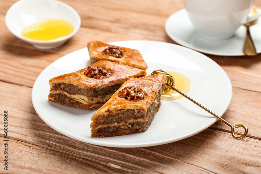 Plate with tasty baklava on wooden background Plate with tasty baklava on wooden background