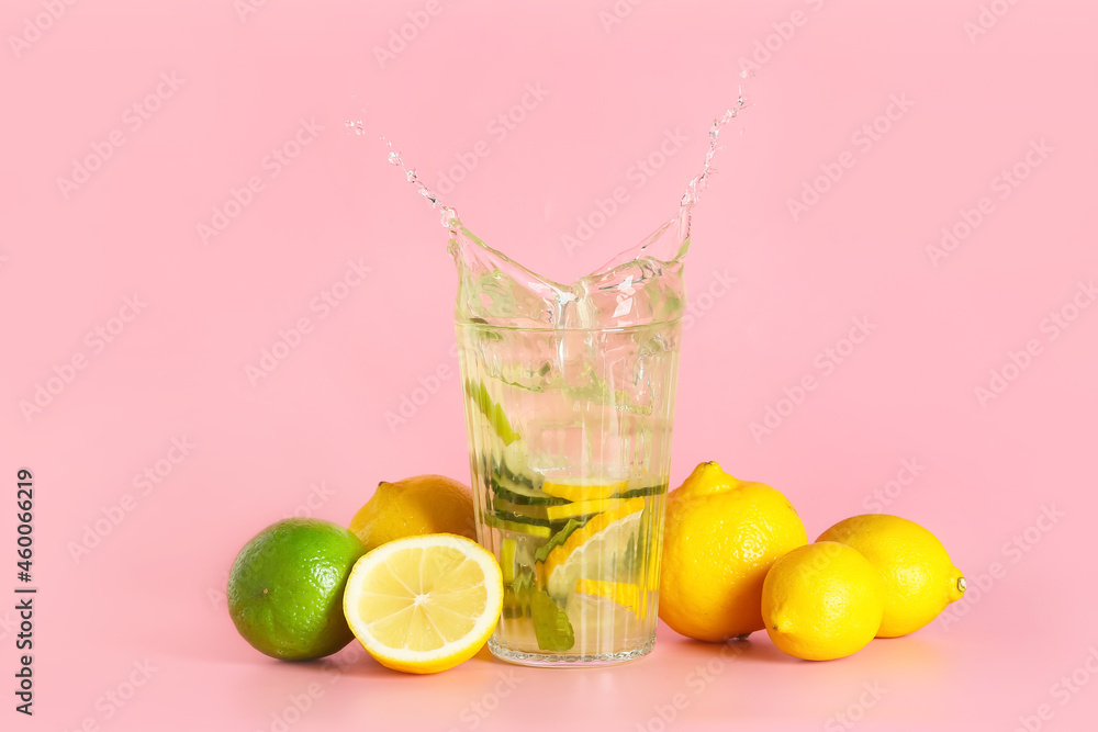 Glass of fresh tasty lemonade with splash on color background Glass of fresh tasty lemonade with splash on color background