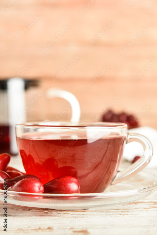 Glass cup of natural dogwood drink on light table, closeup Glass cup of natural dogwood drink on light table, closeup