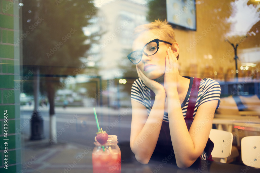 woman sitting in a cafe cocktail looking out the window leisure lifestyle woman sitting in a cafe cocktail looking out the window leisure lifestyle