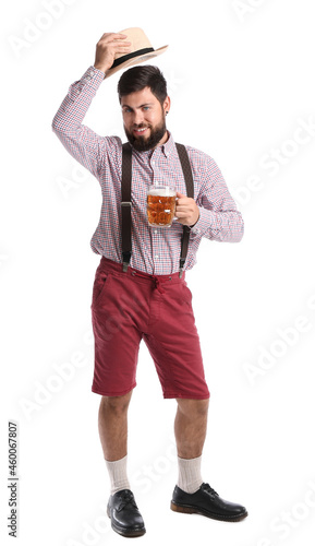 Handsome man in traditional  German clothes and with beer on white background © Pixel-Shot