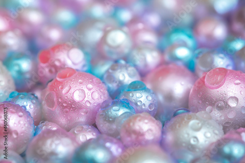 Beautiful background with pearl pearls, top view. Abstract texture for festive backgrounds. Shiny surface of Christmas decorations. Gems close-up. Multicolored bright background.